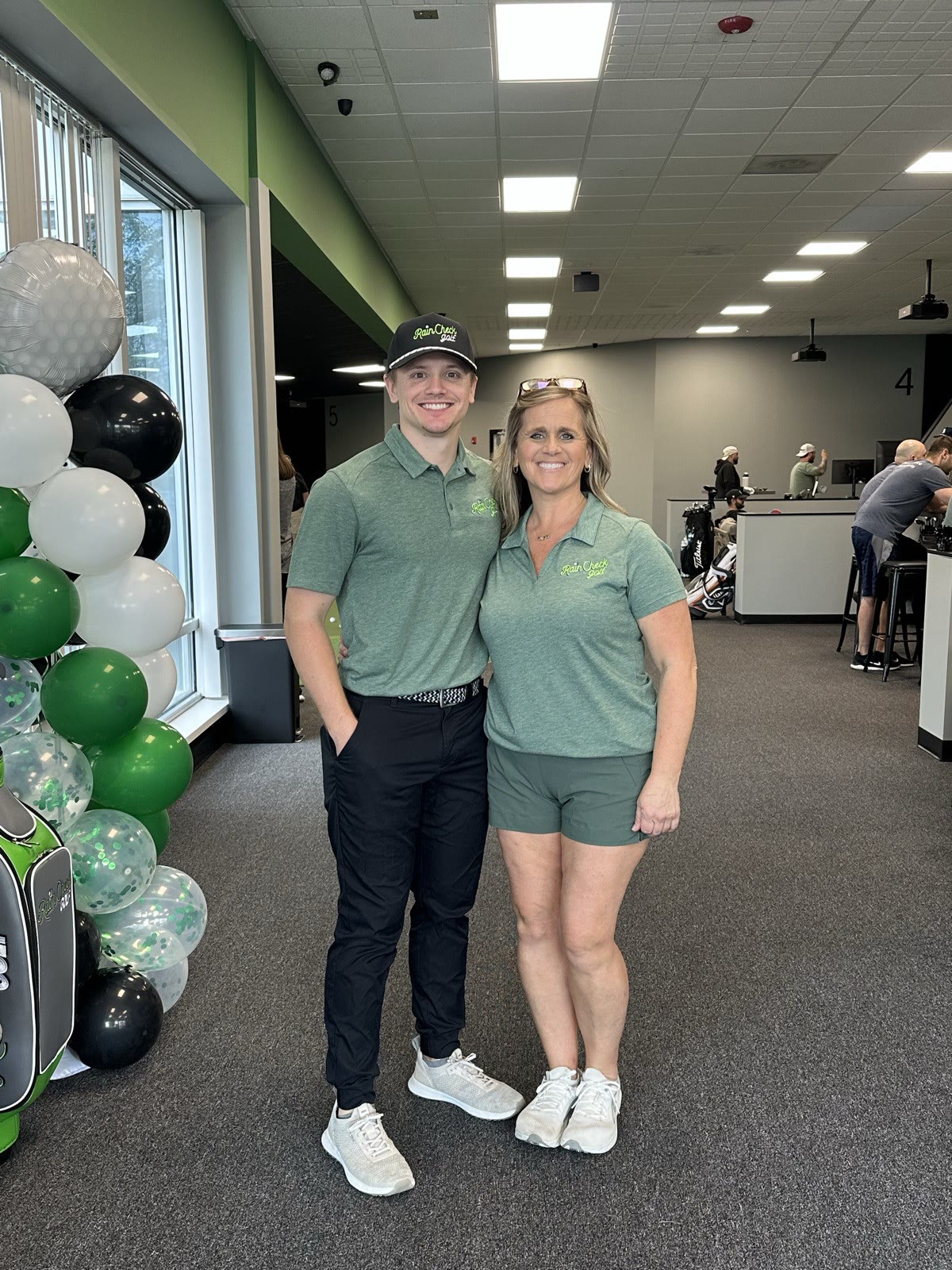 Leanne and Cory, the mother and son owners of Rain Check Golf, inside the facility
